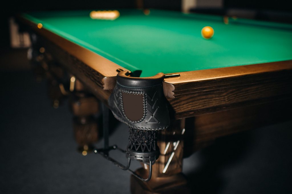 Billiard table with green surface and balls in the billiard club